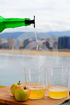 Pouring of natural Asturian cider made fromÂ fermented apples in barrels should be poured from great height for air bubbles